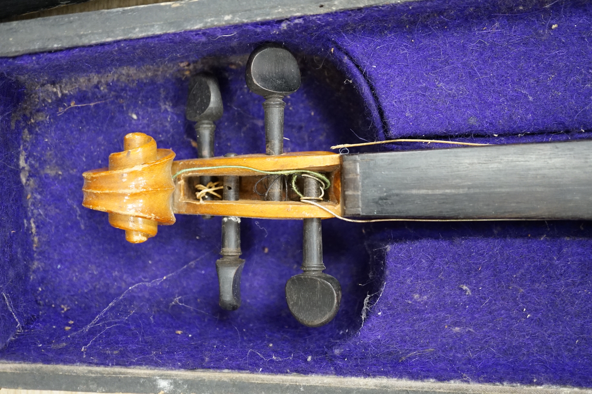 A wooden cased early 20th century Czechoslovakian student’s violin, bears ‘Copy of Stradivarius’ label, body length, 35.5cm, without bow